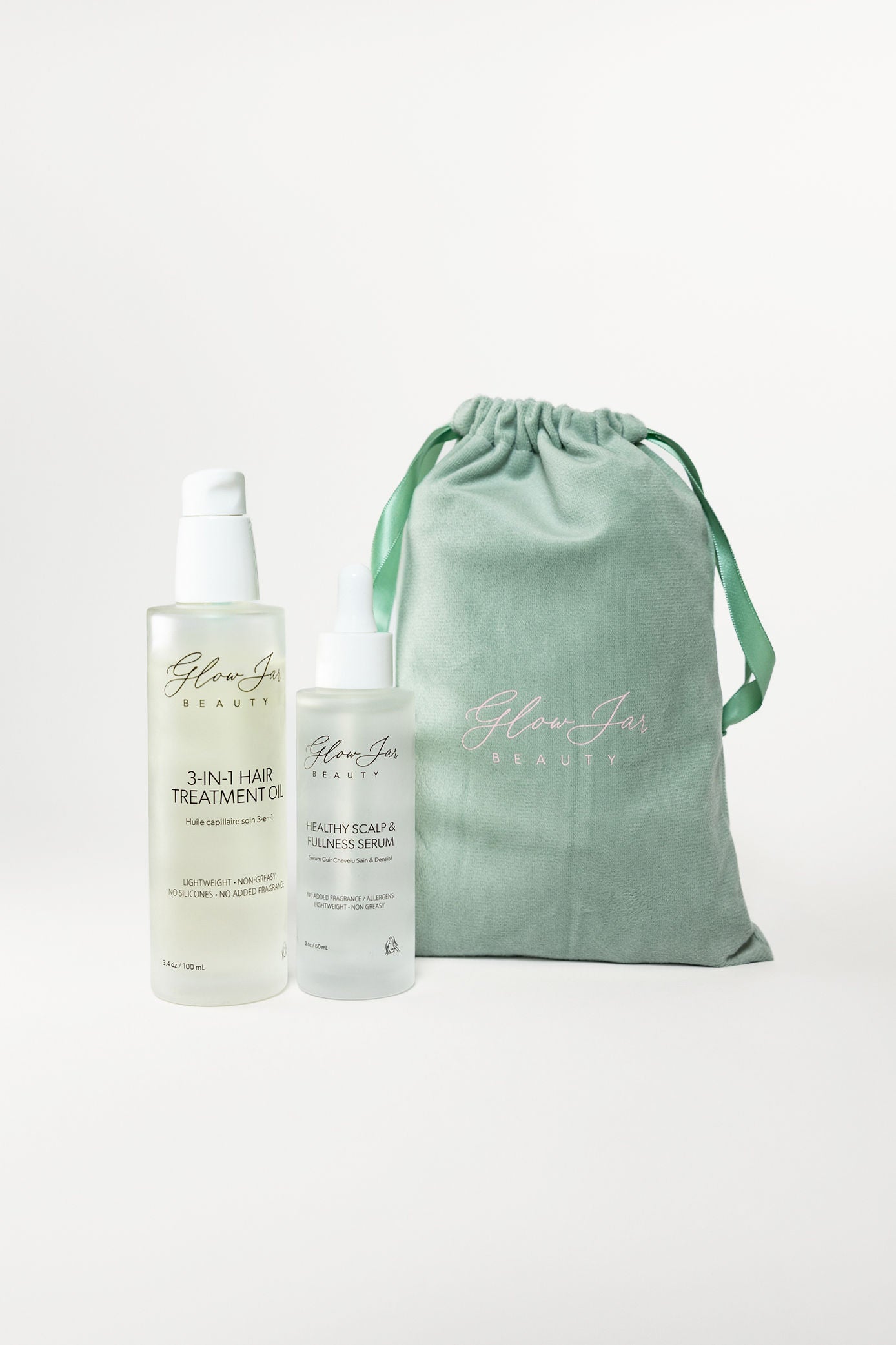Glow Jar Beauty 3-In-1 and Healthy Scalp Serum bottles and a green drawstring bag on a white background