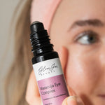 Glow Jar Beauty Maracuja Eye Complex bottle held by a person with a neutral background