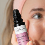 Glow Jar Beauty Maracuja Eye Complex bottle held by a person with a neutral background