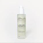 Glass bottle of 3-in-1 hair treatment oil on a white background