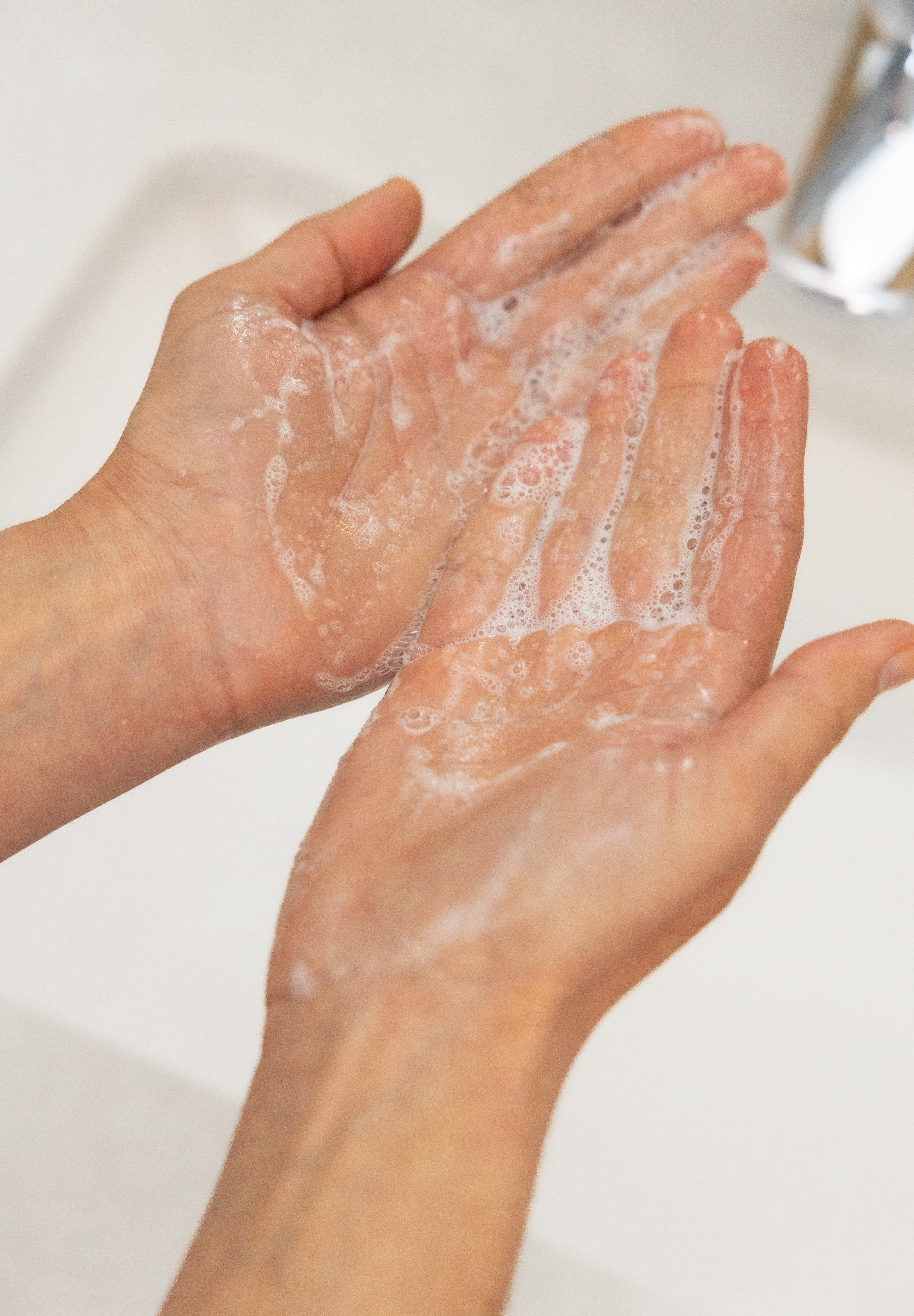 Hands with foaming gentle gel cleanser 